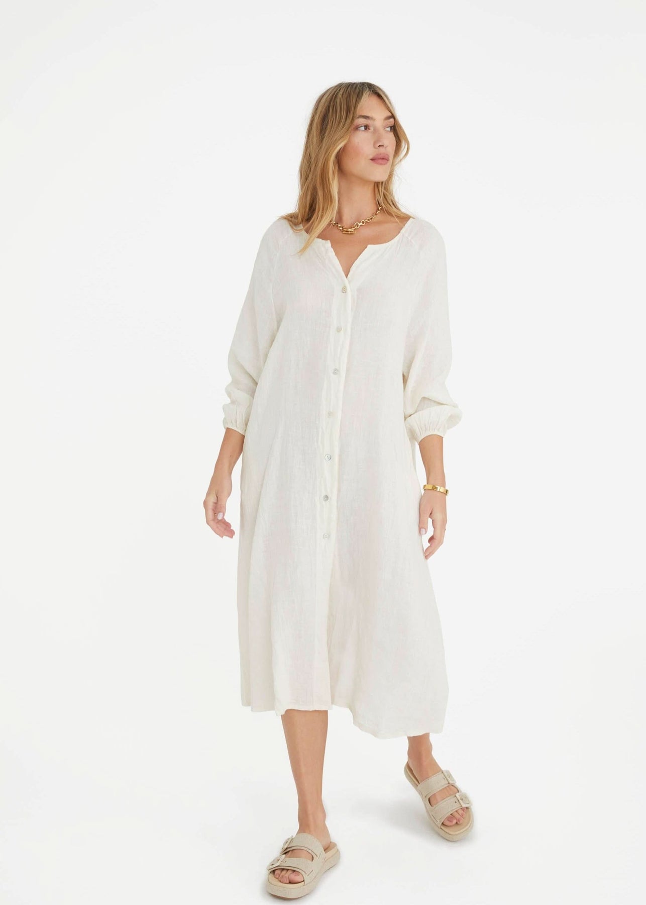 Ecru maternity dress with oversized silhouette, button front, cinched cuff sleeves, and pockets.