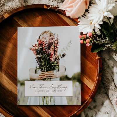 Cover of More Than Anything | Idolatry Study with Bible and journal on wooden table