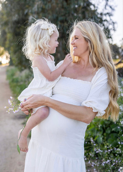 Ivory smocked muslin dress with ruffle sleeves and delicate embroidery