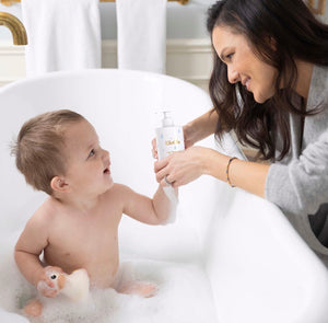 Mom gently bathing her baby, capturing a precious bonding moment using organic baby bath wash by Ellaola
