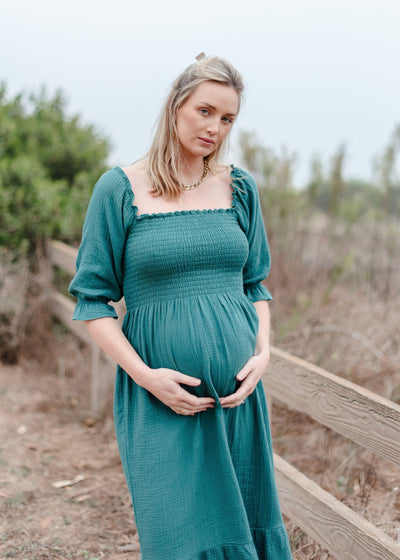 Turquoise smocked muslin dress with floral embroidery and ruffle details