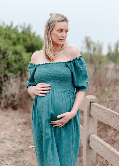 Beautiful sleeveless turquoise dress with smocked bodice and flowy muslin fabric