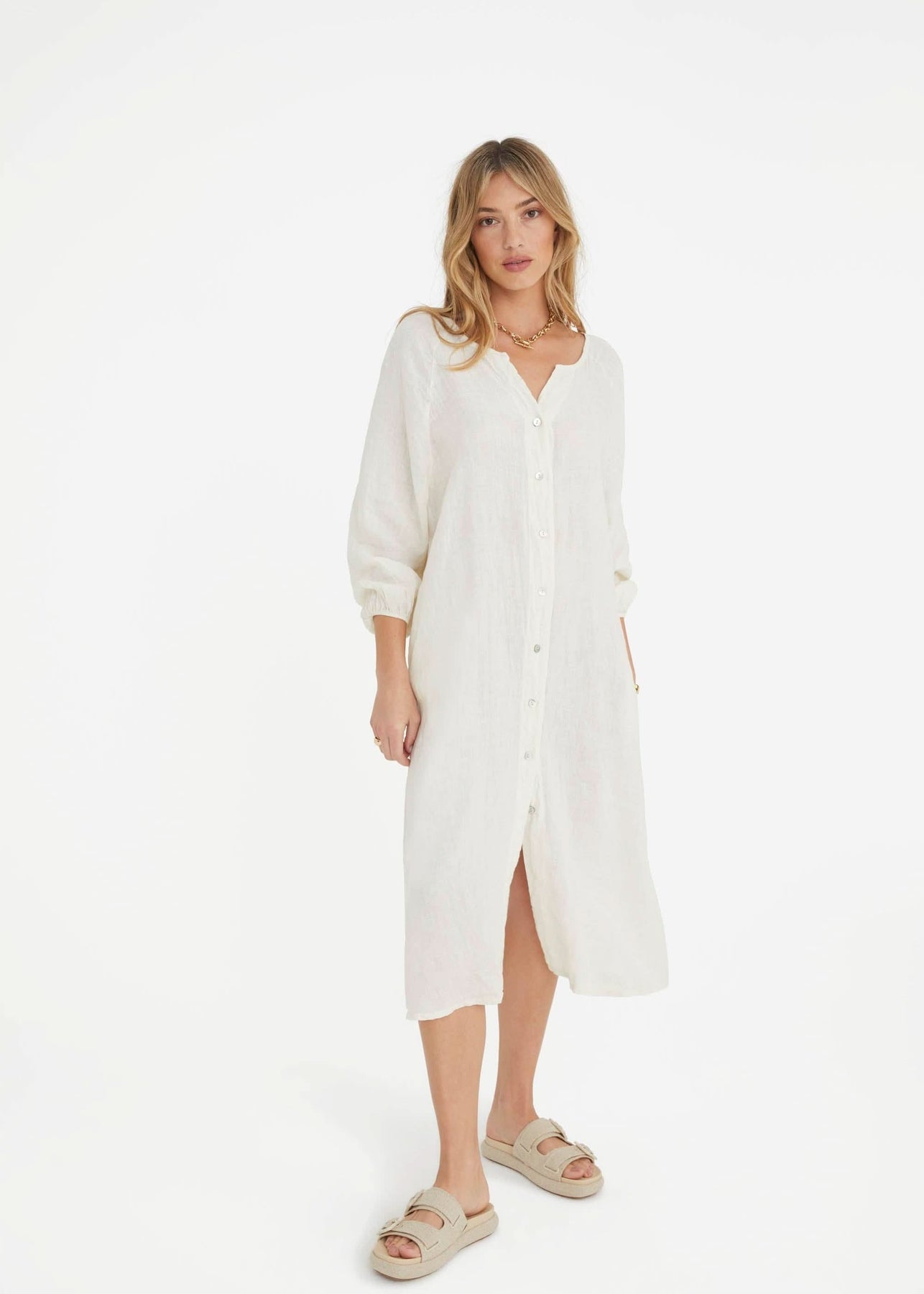 Ecru maternity dress with oversized fit, front buttons, V-neck, cinched cuffs, and pockets