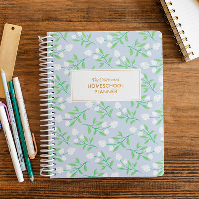 The Daily Grace Co - The Homeschool Planner cover with floral design and daily prompt pages 