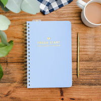 Blue daily goal planner, undated spiral notebook with “Fresh Start” cover text