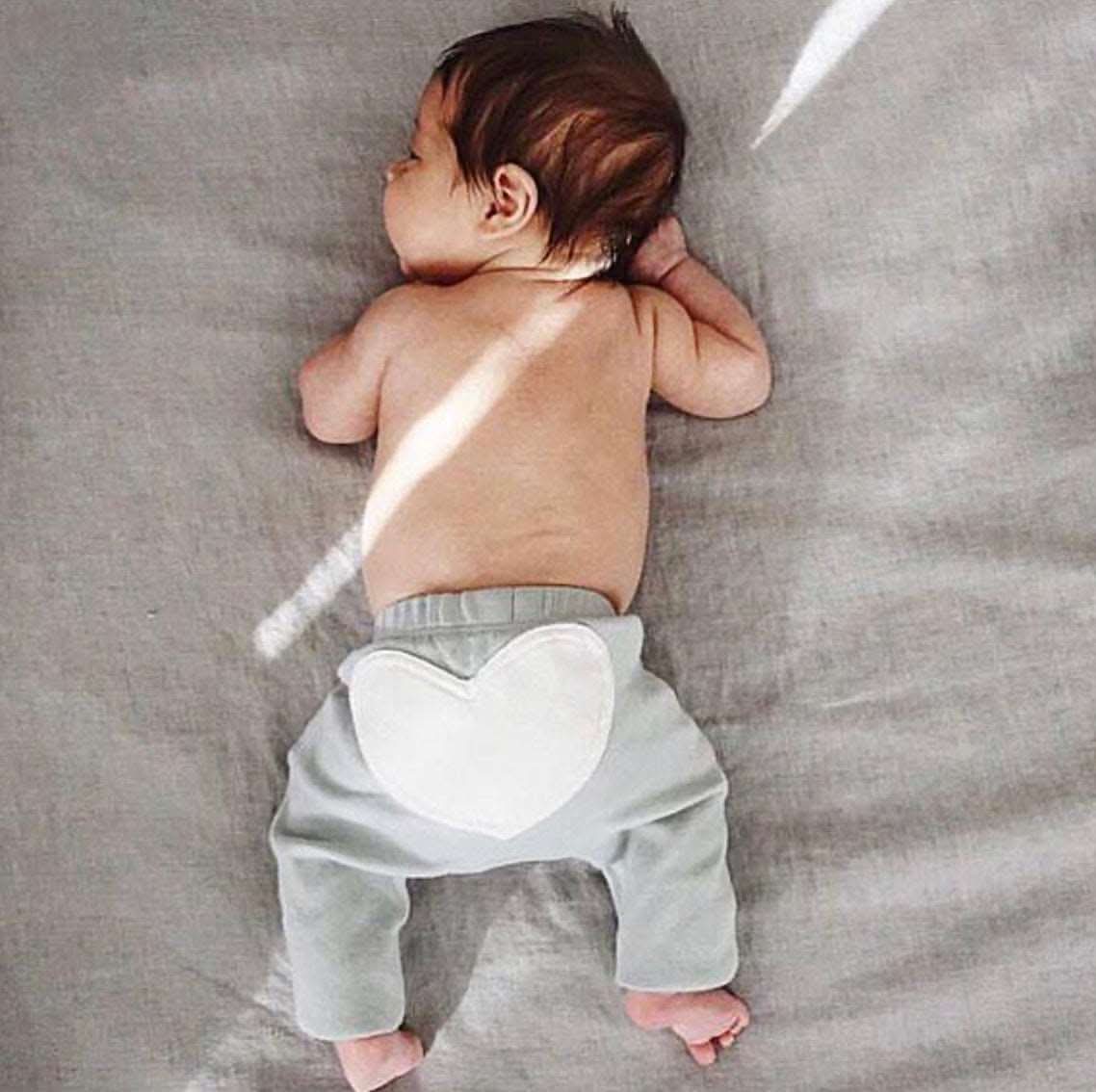 Dove grey baby pants with a heart design and adjustable elastic waist for comfort.