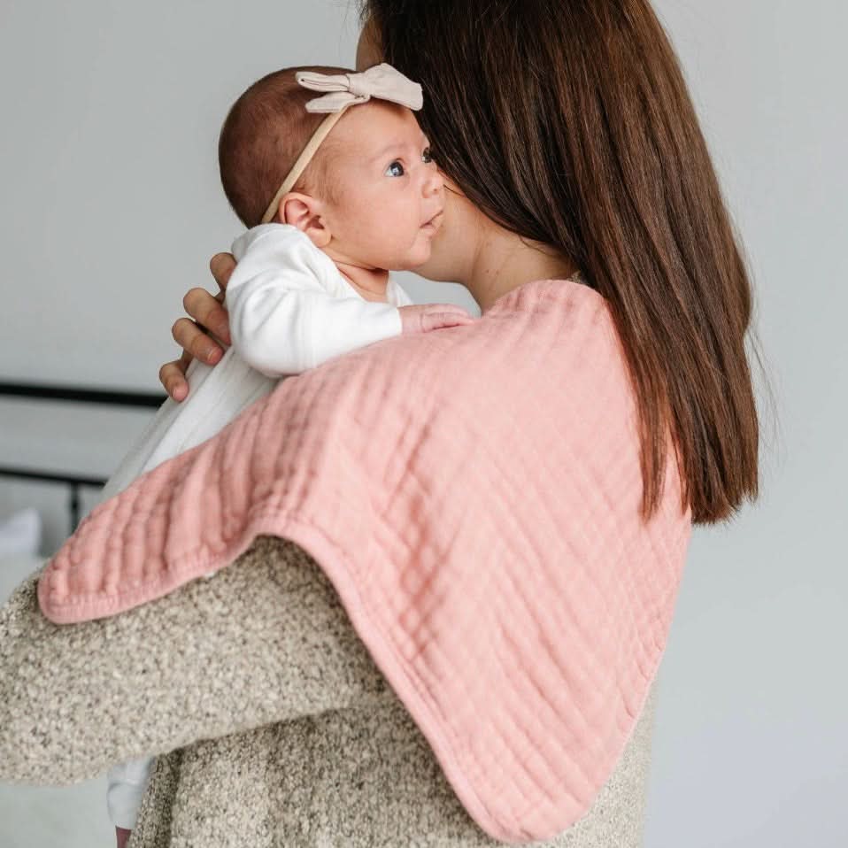 Set of 3 dusty pink muslin bamboo burp cloths, soft and absorbent for baby care.
