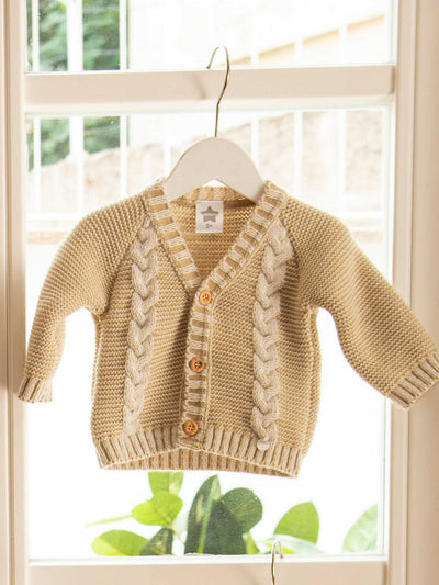 Cozy beige cable knit sweater with a relaxed fit and warm texture