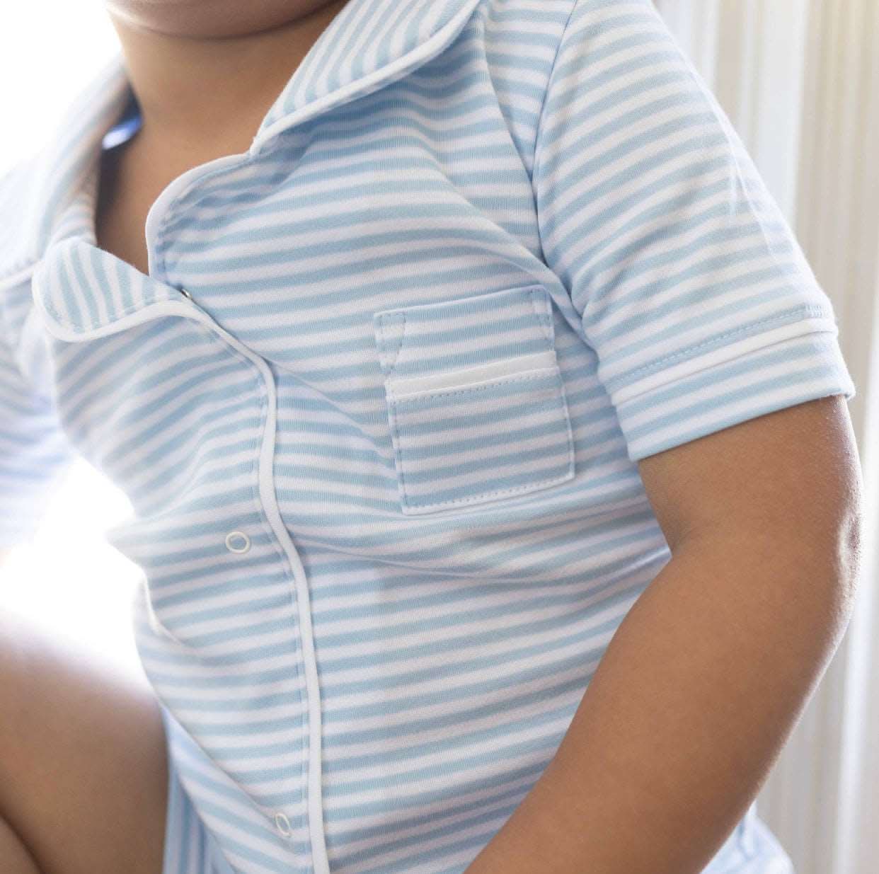 Blue striped Pima cotton pajama set with piping and lapels, including shirt and shorts.